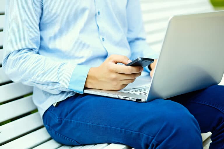 young-man-working-with-laptop-man-s-hands-notebook-computer-business-person-casual-clothes-street