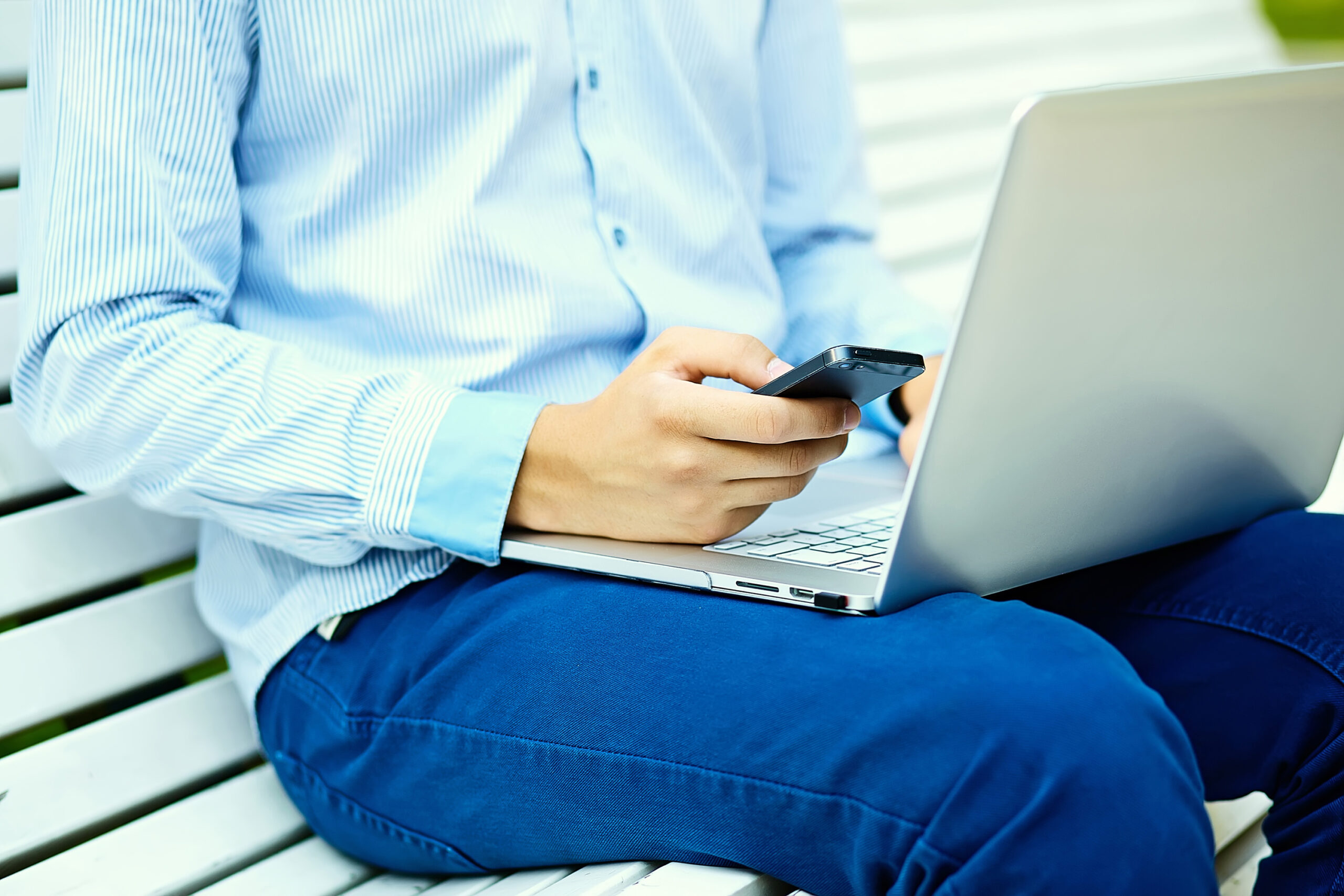 young-man-working-with-laptop-man-s-hands-notebook-computer-business-person-casual-clothes-street